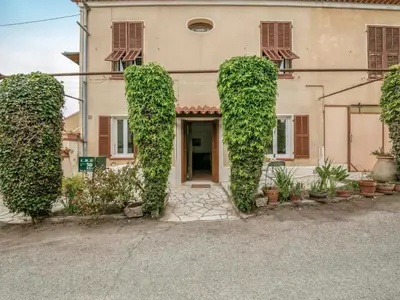 a patio with chairs and a table and a window at Apartment Le Narcisse by Interhome in Cagnes-sur-Mer