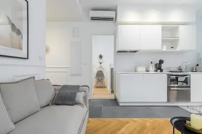 a living room with a couch and a kitchen at HEROLD Balcon in Nice