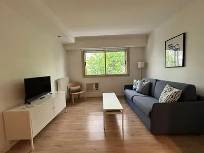 a kitchen with a white refrigerator and cabinets at LE CLIO CARRÉ D'OR BEACH APARTMENT in Nice