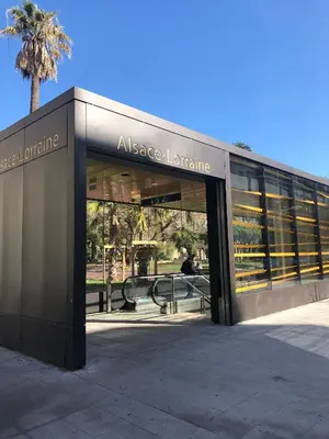 an entrance to a large building with a palm tree at LE CLIO CARRÉ D'OR BEACH APARTMENT in Nice