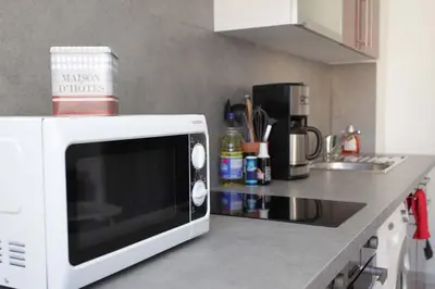 a white microwave oven sitting on top of a kitchen counter at Studio à Nice ensoleillé proche centre et plage in Nice