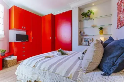 a bedroom with red cabinets and a bed at MY CASA - BERLIOZ 1 - City Center 2 rooms - Balcony in Nice