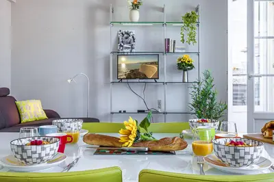 a table with bread and bowls of food on it at MY CASA - BERLIOZ 1 - City Center 2 rooms - Balcony in Nice