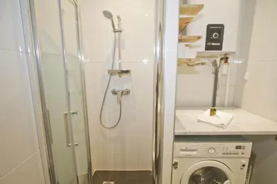 a bathroom with a shower and a washing machine at BEACHSIDE SUITE PANORAMIC - PROMENADE HOLIDAY in Nice
