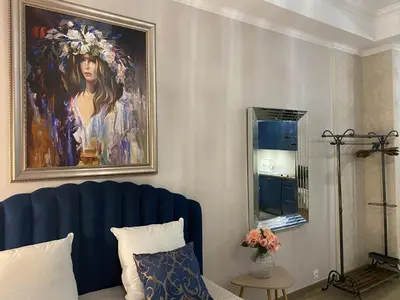 a living room with a painting of a woman at Large beautiful studio near the NEGRESCO HOTEL in Nice