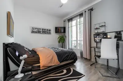 a bedroom with a bed in a room with a window at Beau 3 pièces, 7 pers, 2 terrasses, centre, calme, sécurité in Nice