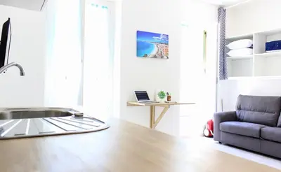 a kitchen with a counter top and a couch at NICE - Studio cosy hypercentre à 500m de la plage in Nice