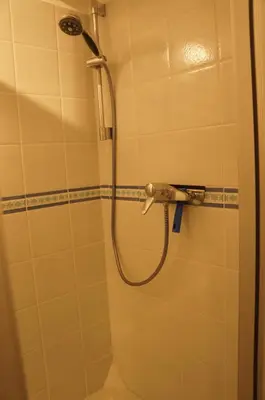 a shower with a shower head in a bathroom at Appartement T3 Climatisé entre mer et centre Nice in Nice