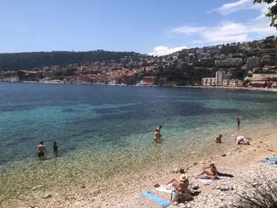 a group of people in the water at a beach at Les Lauriers in Villefranche-sur-Mer