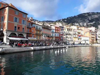 a group of buildings next to a body of water at Les Lauriers in Villefranche-sur-Mer