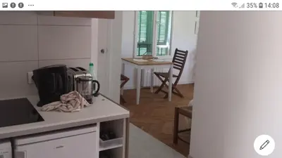 a kitchen with a table and a counter top at Les Lauriers in Villefranche-sur-Mer