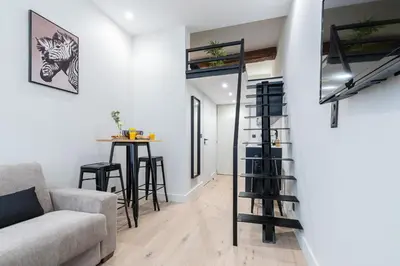 a living room with a couch and a table at Studio Duplex - Vieux Nice - 100m de la mer in Nice