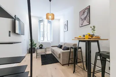 a living room with a couch and a table at Studio Duplex - Vieux Nice - 100m de la mer in Nice