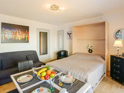 a bedroom with a bed and a table with bananas on it at Studio Le Baccara by Interhome in Cagnes-sur-Mer