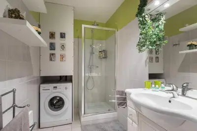 a bathroom with a sink and a washing machine at 8 CONDAMINE - Stylish in Old Town - 2 pièces - 300m de la mer in Nice