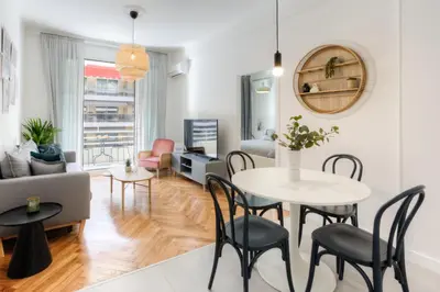 a living room with a table and chairs at #29 Suite Gambetta AC Sea view 2 bedrooms 1min Walk to Promenade & Sea in Nice