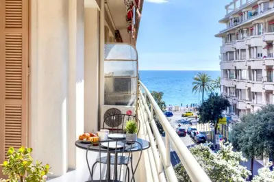 a kitchen with white cabinets and a sink and a microwave at #29 Suite Gambetta AC Sea view 2 bedrooms 1min Walk to Promenade & Sea in Nice