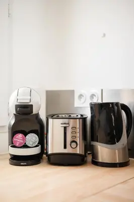 two coffins and a coffee maker on a counter at Cosy & Chill Appartements - 10 min de la mer - Jardin, Netflix, terrasse, fibre & parking in Cagnes-sur-Mer