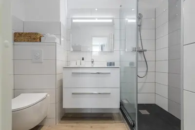 a white bathroom with a sink and a shower at Lovely Apartment City Center Heart - AC in Nice