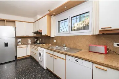 a kitchen with a white refrigerator and a sink at Villa piscine Eze bord de mer à 500m de la plage in Èze