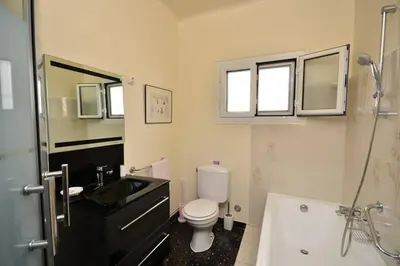 a bathroom with a toilet and a sink and a tub at Villa piscine Eze bord de mer à 500m de la plage in Èze