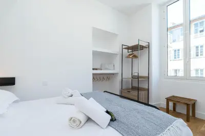a white bedroom with a bed with towels on it at Cosy 1 Bdr Place Garibaldi & Place du Pin in Nice