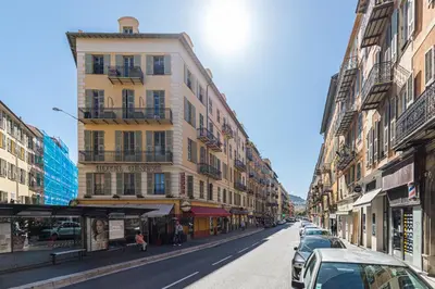 a city street with buildings and cars parked on the street at Cosy 1 Bdr Place Garibaldi & Place du Pin in Nice