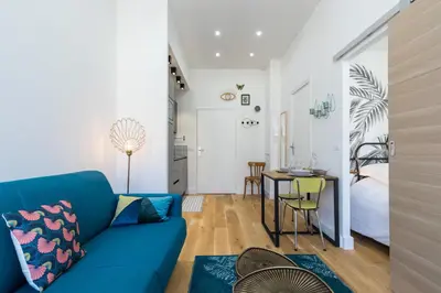 a living room with a blue couch and a table at Cosy 1 Bdr Place Garibaldi & Place du Pin in Nice