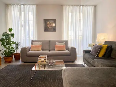 a living room with a couch and a table at Cozy 2BR Appartment near the Port of Nice in Nice
