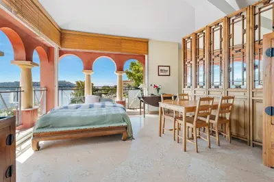 a bedroom with a bed and a table and chairs at Penthouse La Bellevue in Villefranche-sur-Mer