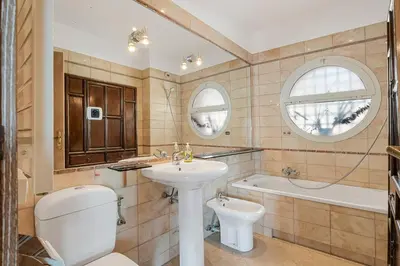 a bathroom with a sink and a toilet and a tub at Penthouse La Bellevue in Villefranche-sur-Mer
