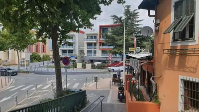 a view of a city street with a tree and buildings at COTE VILLAGE in Nice
