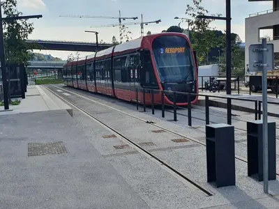 a red train is on the tracks at COTE VILLAGE in Nice