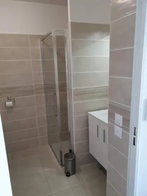 a shower with a glass door in a bathroom at COTE VILLAGE in Nice