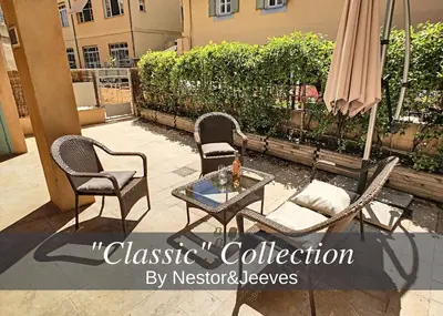 a patio with three chairs and a table and an umbrella at Nestor&Jeeves - HOLIDAY VIBES - Very close sea - Free parking in Nice