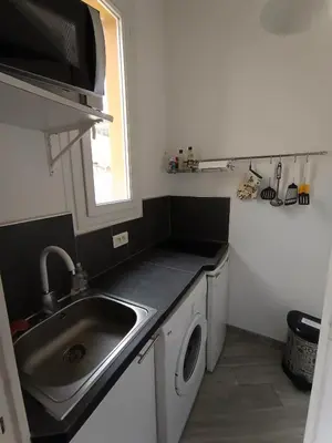 a kitchen with a sink and a washing machine at Charmant studio climatisé centre Villefranche sur mer in Villefranche-sur-Mer