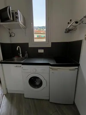 a kitchen with a washing machine and a sink at Charmant studio climatisé centre Villefranche sur mer in Villefranche-sur-Mer