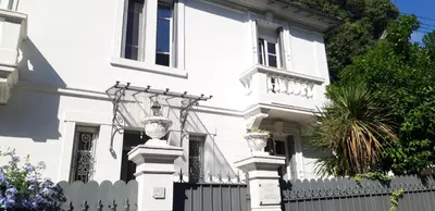 a white house with a white picket fence at Villa Angelus in Nice