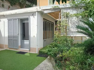 a house with a garden with green grass at Villa Angelus in Nice