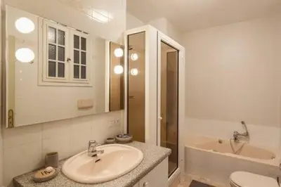 a bathroom with a sink and a toilet and a tub at Le GIULIANO in Nice