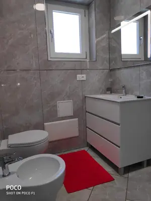 a bathroom with a white sink and a toilet at Logement de Catherine in Nice
