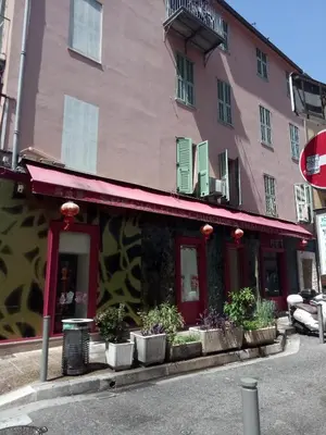 a pink building with potted plants in front of it at Logement de Catherine in Nice