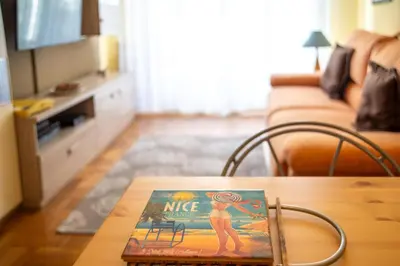 a magazine sitting on a table in a living room at Joli 2 pièces climatisé à 150m de la plage in Nice