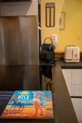 a magazine sitting on top of a kitchen counter at Joli 2 pièces climatisé à 150m de la plage in Nice