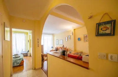 a living room with an archway and a living room with a couch at Joli 2 pièces climatisé à 150m de la plage in Nice