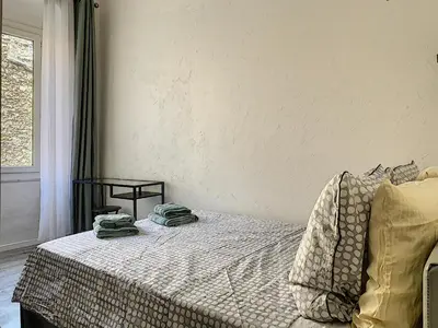 a bedroom with a bed with two towels on it at 2-bedrooms аpartment Nice Port with parking in Nice