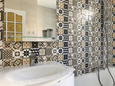 a bathroom with a tub and a tiled wall at 2-bedrooms аpartment Nice Port with parking in Nice