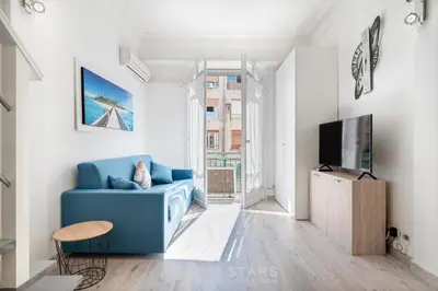 a living room with a blue couch and a tv at Studio Imperator Five stars holiday house in Nice