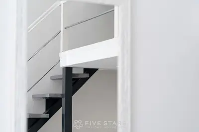 a stair case in a building with white walls at Studio Imperator Five stars holiday house in Nice