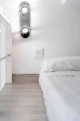 a bedroom with a bed and a light on the wall at Studio Imperator Five stars holiday house in Nice